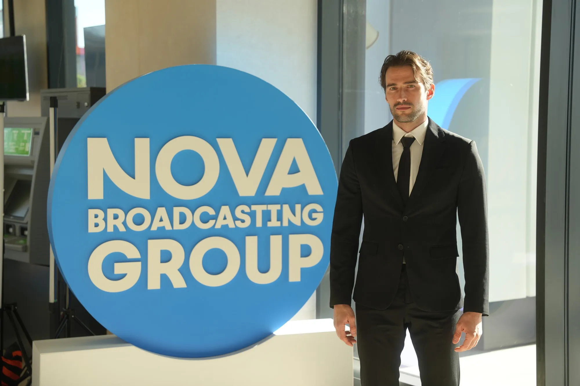 Martin Mednikarov beside the NOVA Broadcasting Group sign