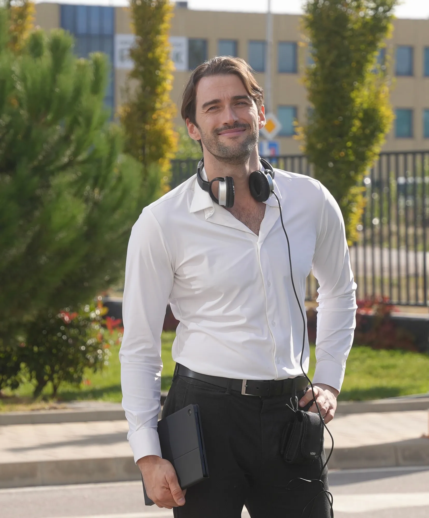 Martin Mednikarov on location, wearing headphones and holding a tablet